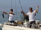 Due dei concorrenti, Fabio Comini, a sinistra, e Maurizio Manna, esibiscono le rispettive prede